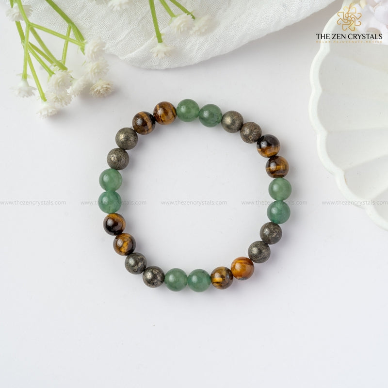 Business Success Energy Bracelet on a white surface with flowers in the background, branded 'The Zen Crystals'.