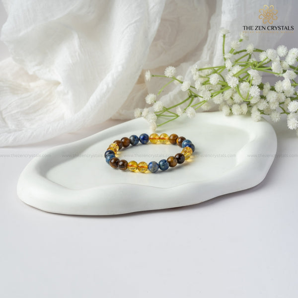 Confidence Energy Bracelet on a white dish with white flowers and 'The Zen Crystals' branding.