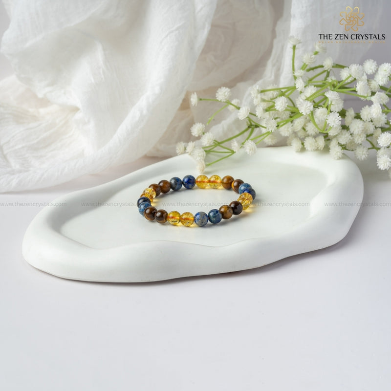 Confidence Energy Bracelet on a white dish with white flowers and 'The Zen Crystals' branding.
