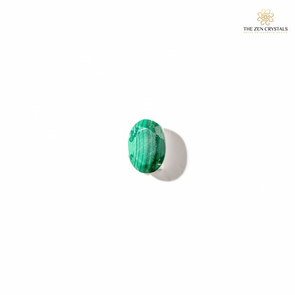 Green malachite stone on a white background with 'The Zen Crystals' branding.