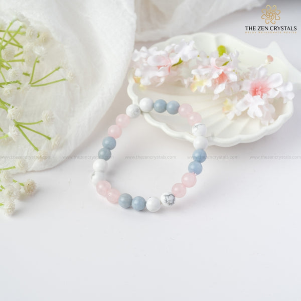 peaceful meditation bracelet on a white surface with flowers and 'The Zen Crystals' branding.