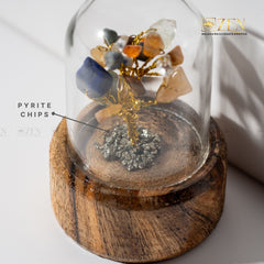 Crystal tree with pyrite chips and stones on a wooden base