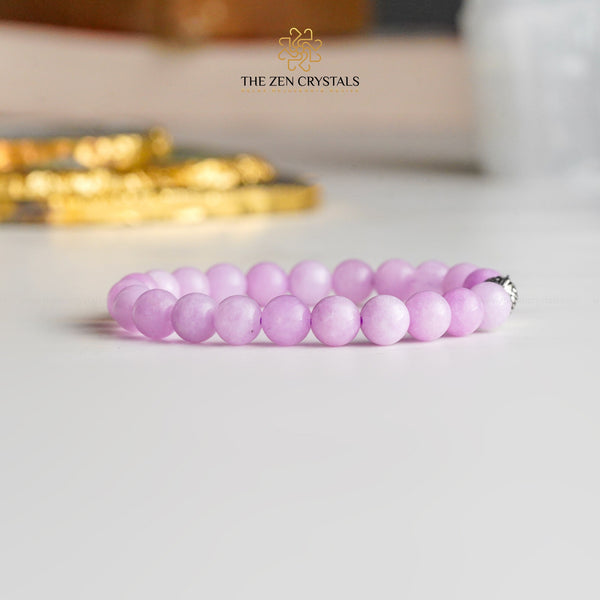 kunzite bracelet on a light surface with 'The Zen Crystals' branding.