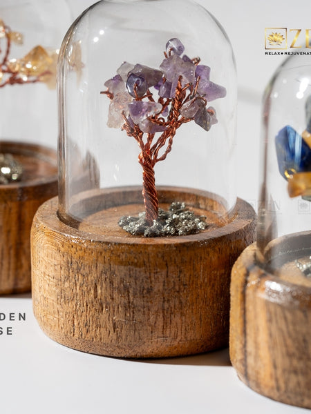 Decorative tree with crystals on a wooden base under a glass dome by The Zen Crystals