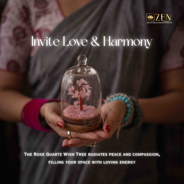 Person holding a glass dome with a rose quartz wish tree, promoting love and harmony.