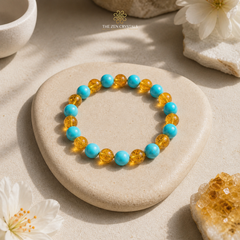 Turquoise and citrine  beaded bracelet on a stone with flowers and crystals around