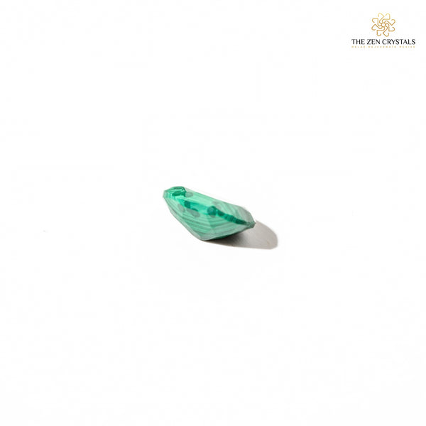 Green malachite stone on a white background with 'The Zen Crystals' logo.