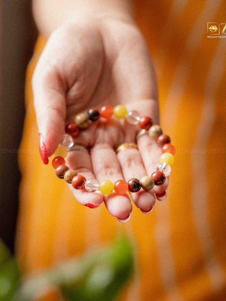 ruling number 9 bracelet held in a hand against an orange background with 'ZEN' branding.