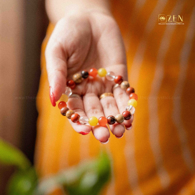 ruling number 9 bracelet held in a hand against an orange background with 'ZEN' branding.