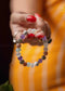 Colorful beaded bracelet on a hand with a blurred background
