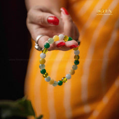 close-up image of a hand holding the rulingn number 5 bracelet