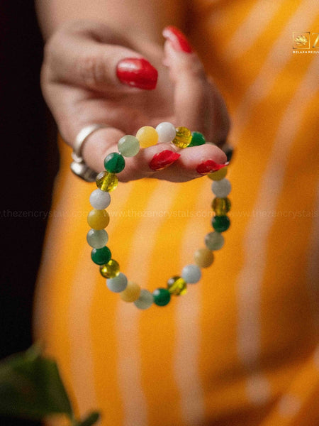 close-up image of a hand holding the rulingn number 5 bracelet