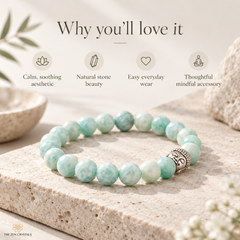 A beaded bracelet made of round light aqua and white marbled stones with a silver Buddha bead accent, displayed on a textured stone slab with promotional text above reading 'Why you'll love it' and small feature icons.
