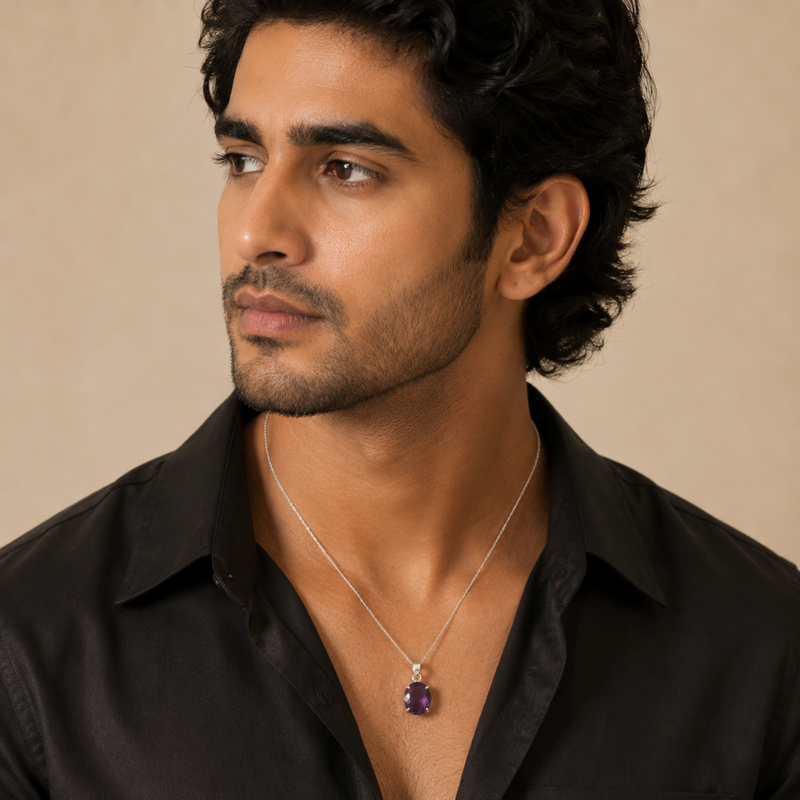 A man wearing an Amethyst pendant, shown in a close-up portrait against a warm beige background.