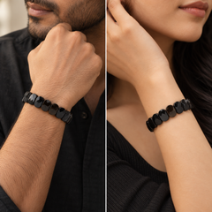 A split-screen lifestyle image showing a Faceted Black Obsidian bracelet worn on a man's wrist and a woman's wrist. The bracelet consists of glossy, rounded black discs.