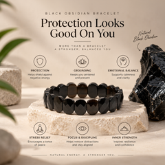 A black obsidian beaded bracelet displayed on a stone pedestal with a large black mineral specimen beside it. The image includes marketing text about the bracelet's spiritual benefits and uses a soft beige background with subtle plant leaves.