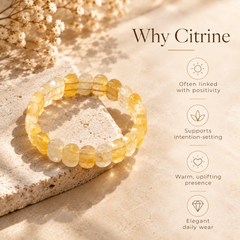 A beaded stretch bracelet made of translucent yellow citrine stones, displayed on a textured stone slab with dried flowers. The image includes informational text on the right explaining the benefits of citrine.