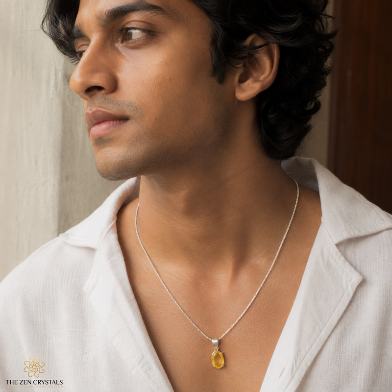 A man wearing faceted citrine pendant, styled with a white collared shirt. The brand logo 'THE ZEN CRYSTALS' is visible in the bottom-left corner.