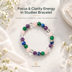 A beaded stretch bracelet for focus and clarity, featuring colorful crystals including green, purple, blue, pink, and clear quartz, displayed on a light marble surface with white flowers and draped fabric. Text overlays read 'Focus & Clarity Energy In Studies Bracelet' and 'The Zen Crystals' logo is visible at the bottom.