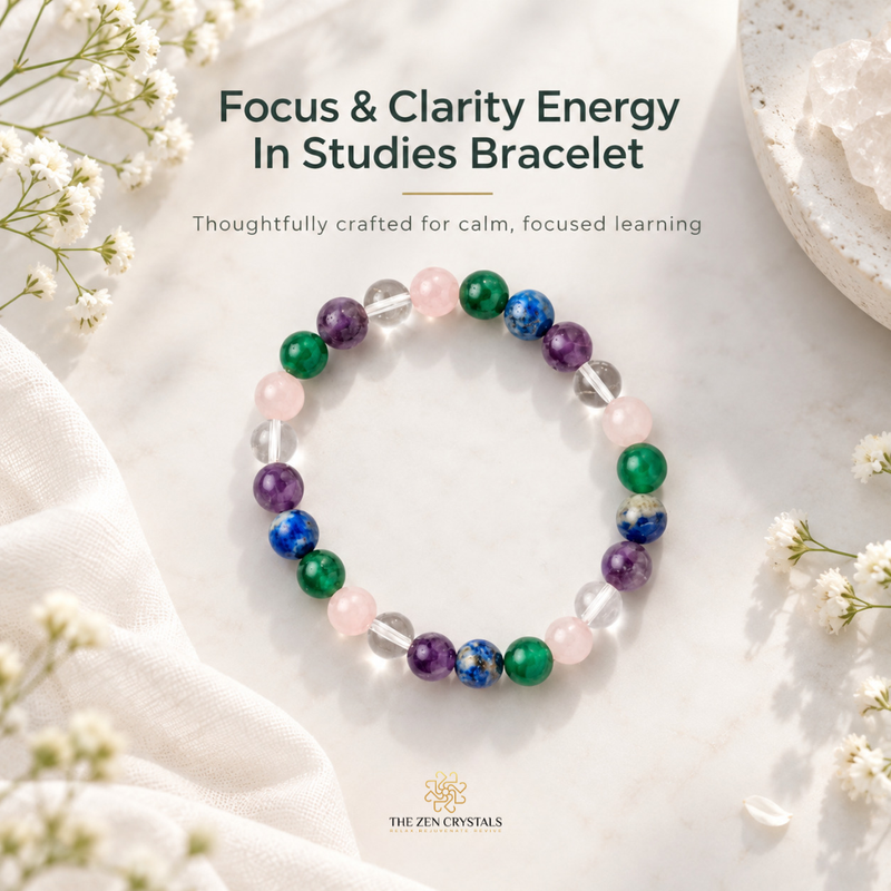 A beaded stretch bracelet for focus and clarity, featuring colorful crystals including green, purple, blue, pink, and clear quartz, displayed on a light marble surface with white flowers and draped fabric. Text overlays read 'Focus & Clarity Energy In Studies Bracelet' and 'The Zen Crystals' logo is visible at the bottom.