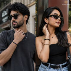 A split-screen lifestyle image showing a man and a woman wearing matching dark sunglasses and Evil Eye bracelet set from The Zen Crystals. The man wears a dark gray t-shirt, and the woman wears a black strapless top and light-wash jeans.
