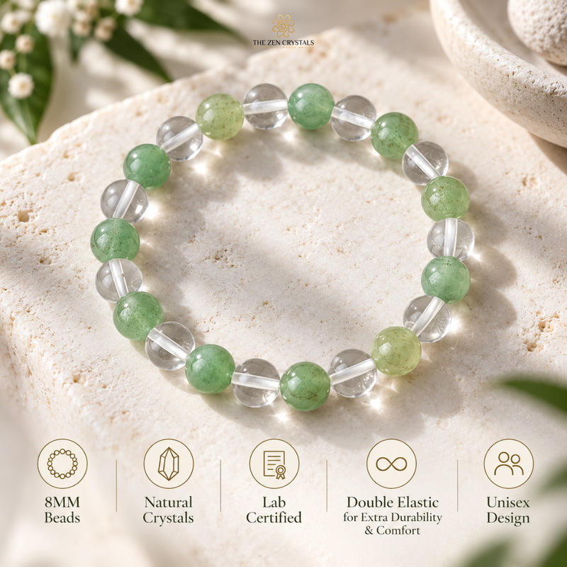 A beaded stretch bracelet made of green and clear round crystals, displayed on a light beige stone slab with decorative leaves and a ceramic bowl in the background. Five feature icons are shown at the bottom.