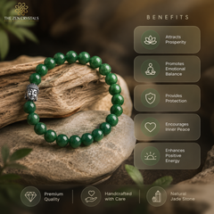 A green jade beaded bracelet with a silver Buddha head charm, displayed on a stone and wood prop with a 'Benefits' infographic overlay on the right.