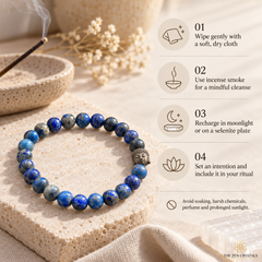 A beaded bracelet made of blue lapis lazuli stones with a small silver-toned metal charm, displayed on a textured stone slab. The image includes a detailed usage guide on the right side with icons and text for cleansing, charging, and ritual use.