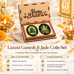 An open wooden gift box displaying two round green jade coins, one with Lord Ganesha and the other with Lakshmi, on a marble surface with Diwali decorations, candles, and marigold flowers. Text below reads 'Laxmi Ganesh Ji Jade Coin Set' with additional product benefits.