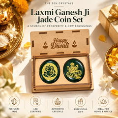 Laxmi Ganesh Ji Jade Coin Set by The Zen Crystals, presented in an open wooden box with 'Happy Diwali' engraved inside. The set includes two round dark green jade coins with gold-toned engravings, displayed on a warm, decorated background with Diwali-themed props like a brass tray, diyas, and a gift box.