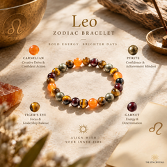 A beaded astrology bracelet for Leo zodiac, featuring orange, tiger's eye, garnet, and pyrite crystals, displayed on a textured beige surface with astrological props and text labels.