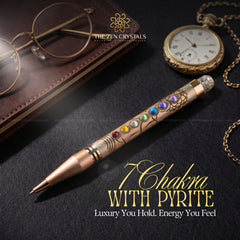 7 chakra pyrite pen with chakra stones on a dark surface with 'The Zen Crystals' branding.