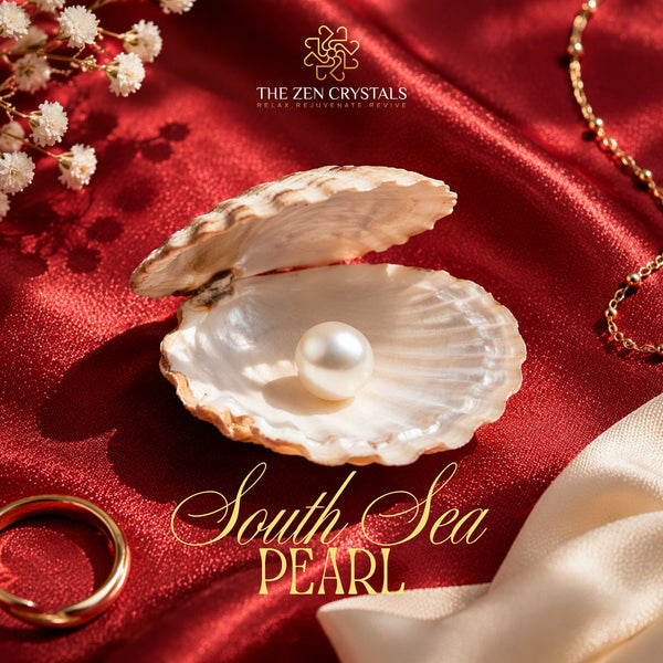 south sea pearl on red fabric, surrounded by gold jewelry and white flowers, with 'The Zen Crystals' branding.
