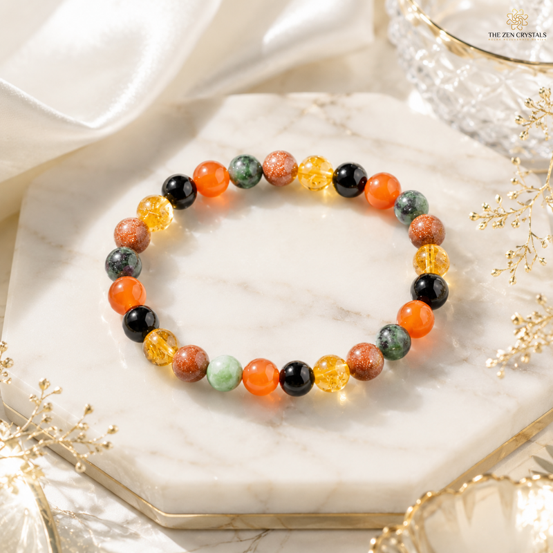 RULING NUMBER 1 BRACELET displayed on a white marble hexagonal tray. The bracelet features a mix of orange, black, green, yellow, and light green polished gemstone beads.