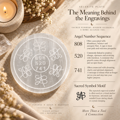 A flat lay of a clear circular crystal plate with engraved floral and geometric patterns, displayed on a beige fabric background with a lit candle, dried flowers, and printed informational text about the meaning behind the engravings.
