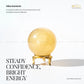 Yellow aventurine crystal on a stand with promotional text on a white background