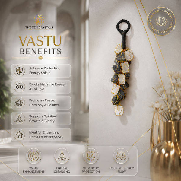 A decorative hanging wall ornament made of stacked black and gold stones with white inlays, shown beside a 'VASTU BENEFITS' infographic on a beige wall. The graphic lists spiritual and energetic benefits, and a gold circular seal reads 'PROTECT + PURIFY ATTRACT POSITIVE'.
